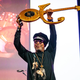 Spike Lee holds Prince’s guitar aloft at Prince: The Beautiful Ones—a Celebration of his Memoir, Life and Art at the Town Hall on Nov. 18, 2019